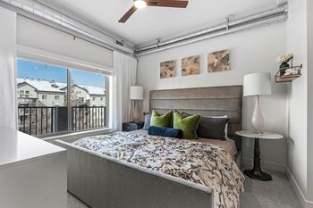 Bedroom with gray upholstered headboard and floral duvet